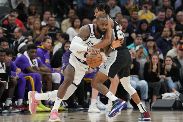 Nov 26, 2022; San Antonio, Texas, USA; Los Angeles Lakers forward LeBron James (6) dribbles in against San Antonio Spurs guard Devin Vassell (24) in the second half at the AT&T Center.